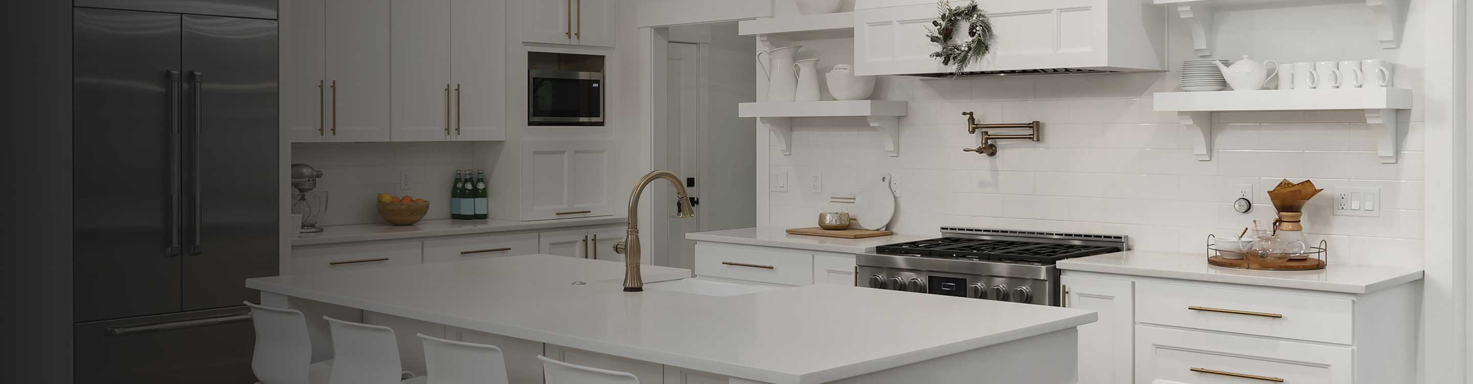 White kitchen with marble floors and a tile backsplash