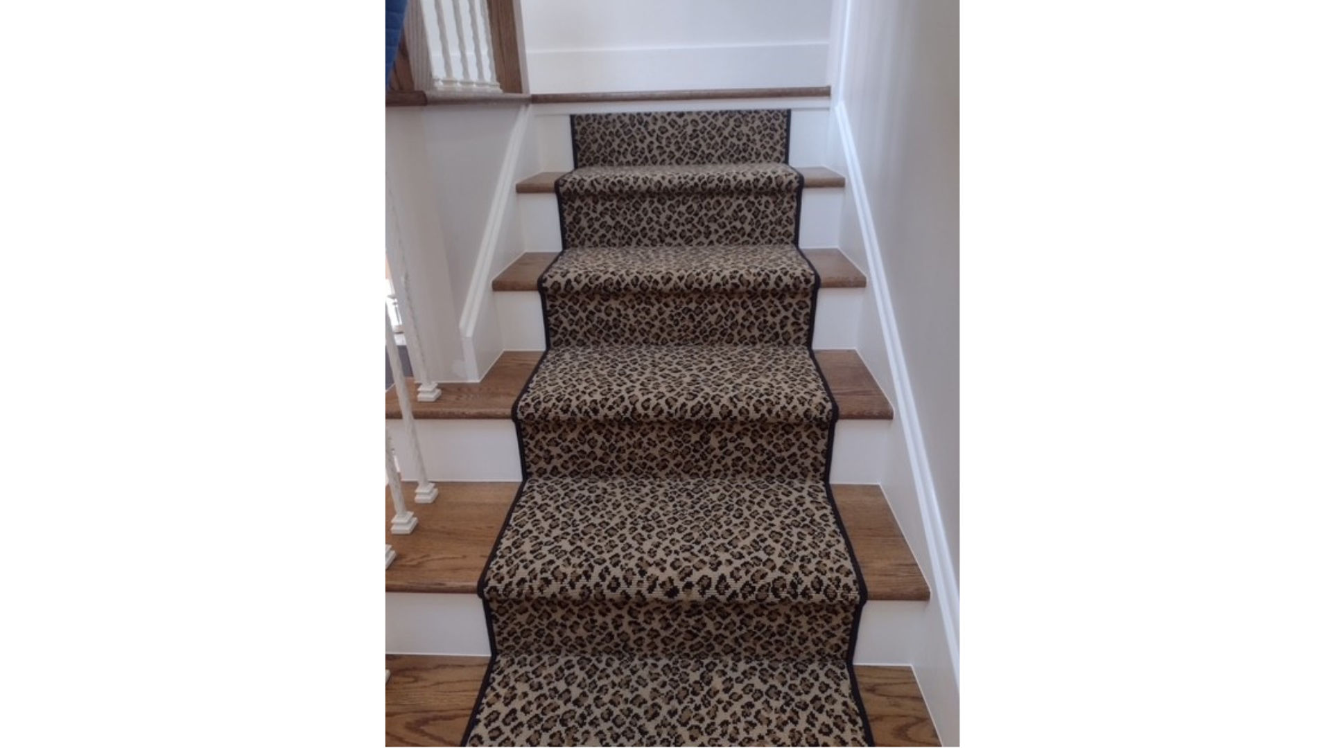 Elegant hardwood staircase with carpet runner